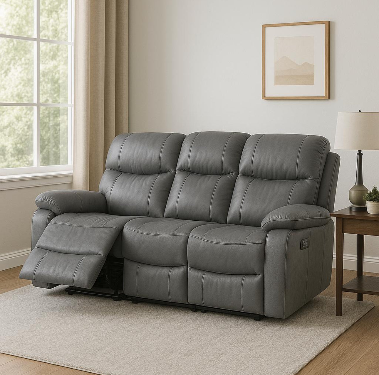 Gray leather recliner sofa in a living room setting with a lamp and framed picture on the wall.